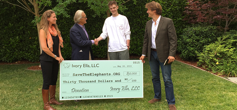 Jacob (Ivory Ella Founder) hands over cheque donation to Dr. Iain Douglas-Hamilton (STE Founder)